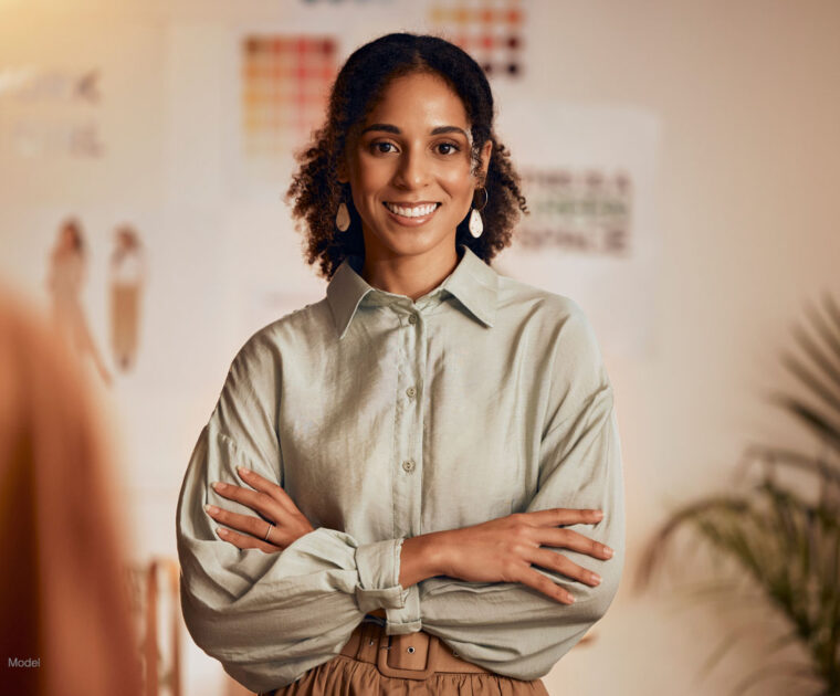 smiling, confident woman with her arms crossed.