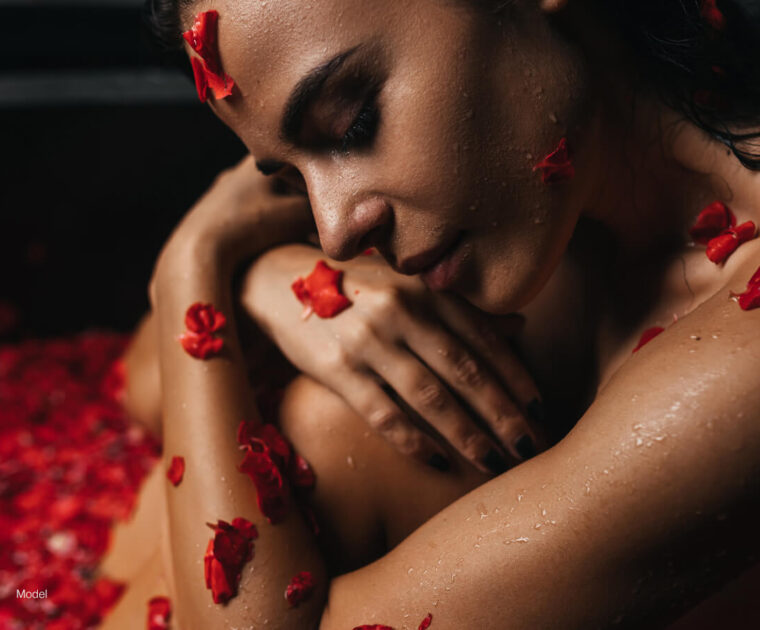 Woman in a bath of flowers