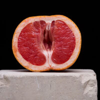 Blood orange cut in half; vagina concept